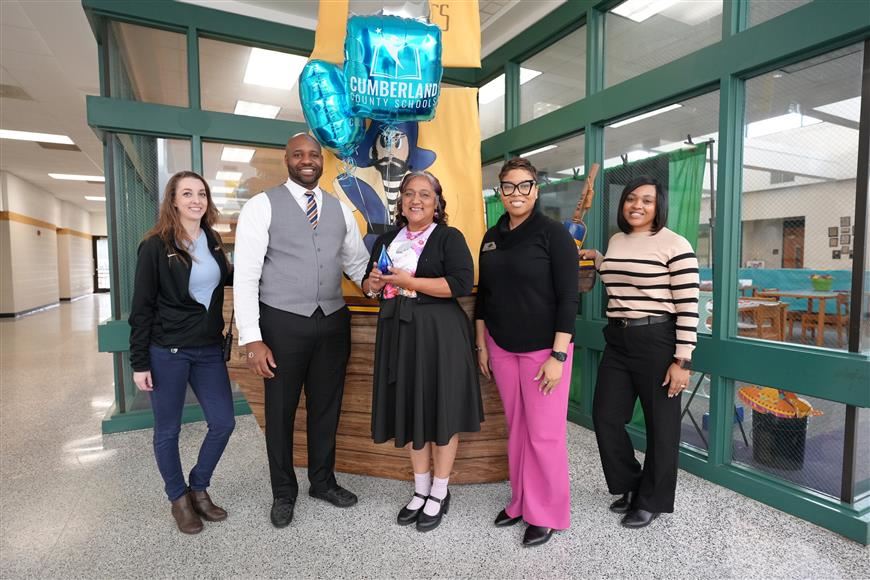 February 2024 Extra Mile Award Winner with Staff